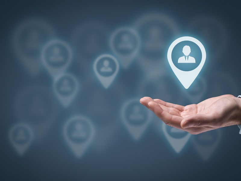 Target audience and customers concept. Man hold target customer in hand, target audience in background.