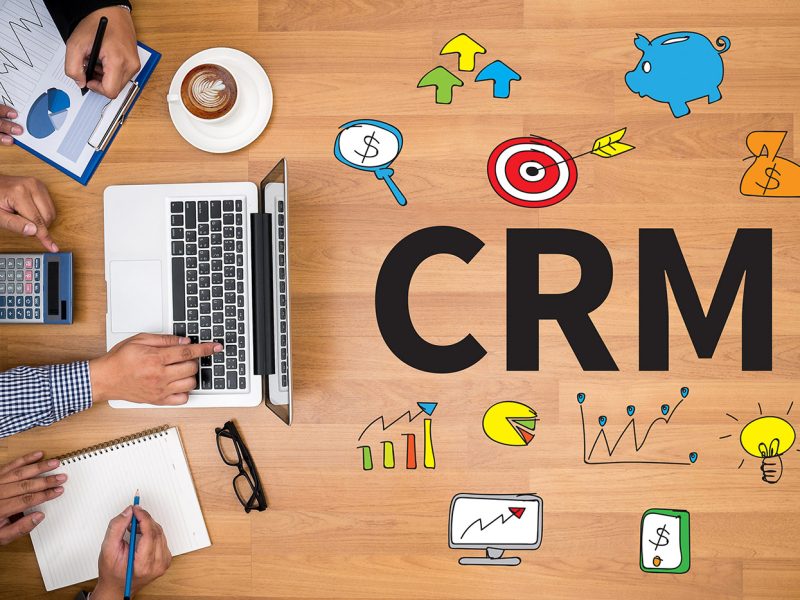 CRM  Business Customer CRM Management Analysis Service Concept  Business team hands at work with financial reports and a laptop