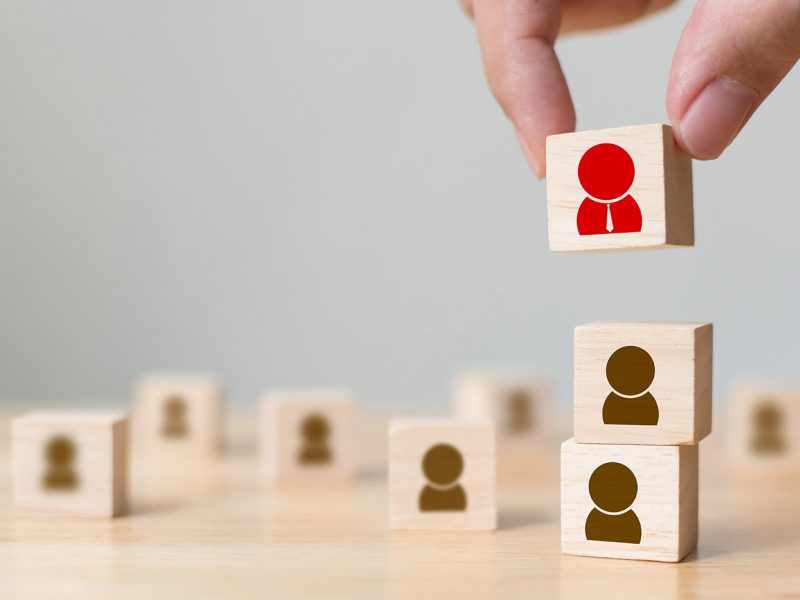 Human resources management and recruitment business build team concept, Hand putting wood cube block on top, Copy space